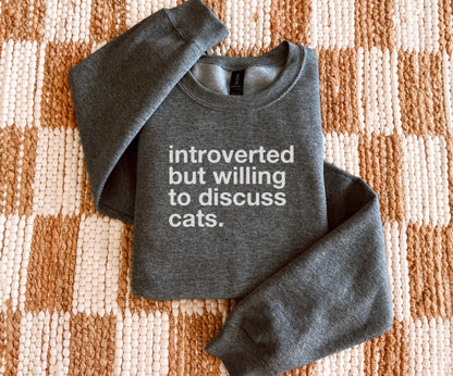 introverted but willing to discuss cats. - Unisex Crewneck Sweatshirt